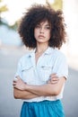 A young female mixed race woman standing with her arms crossed outside looking cool and confident with great style Royalty Free Stock Photo