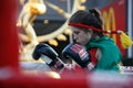 Young female Muay Thai boxing pay respect to the fight