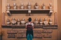 Young female in a museum looking at the statues and enjoying the beautiful artwork in Vatican