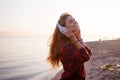 Young beautiful female music fan. Dancing and listening to music on headphones