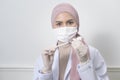 Young female muslim doctor holding a syringe with covid-19 vaccine bottle for injection, covid-19 vaccination and health care Royalty Free Stock Photo