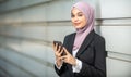 Young Female Muslim Entrepreneur and her smartphone