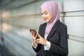 Young Female Muslim Entrepreneur and her smartphone