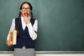 Young female nerd with books and apple