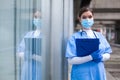 Young female NHS UK EMS doctor in front of healthcare ICU facility Royalty Free Stock Photo