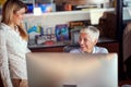 A young female office worker enjoy chatting with her female boss at the workplace. Business, office, job Royalty Free Stock Photo