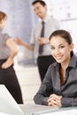 Young female office worker smiling in office Royalty Free Stock Photo