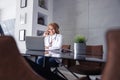 Female online doctor having phone conversation Royalty Free Stock Photo