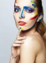 Young female painter with acrylic paint on face Royalty Free Stock Photo