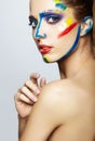 Young female painter with acrylic paint on face Royalty Free Stock Photo