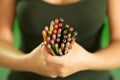 Young female painter holding colored pencils at camera Royalty Free Stock Photo