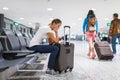 Young female passenger at the airport, using her tablet computer Royalty Free Stock Photo