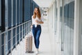 Young, female passenger at the airport, waiting desperately for her delayed flight color toned image; shallow DOF Royalty Free Stock Photo