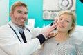 young female patient and happy doctor at office Royalty Free Stock Photo