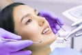 Young Female patient with pretty smile examining dental inspection at dentist clinic. Healthy teeth and medicine, stomatology Royalty Free Stock Photo