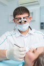 Young female patient receiving dental treatment from a dentist