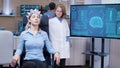 Young female patient sitting on a chair and wearing brainwaves scanning headset