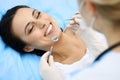 Young female patient visiting dentist office.Beautiful woman with healthy straight white teeth sitting at dental chair