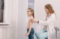 A young female pediatrician examines a girl in the office. Consultations. Diagnosis