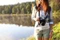 Young female photographer with camera Royalty Free Stock Photo