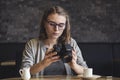 Young female photographer checking an image as she relaxes