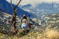 Young female photographer with professional camera near big old tree opposite greek village. A girl with camera opposite the villa Royalty Free Stock Photo