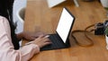 Young female photographer working with tablet computer on wooden table. Royalty Free Stock Photo