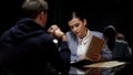 Young female police officer comparing suspect statements with file documents Royalty Free Stock Photo