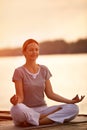 Female practicing yoga near river Royalty Free Stock Photo