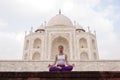 Young female practising yoga meditation at Taj Mahal