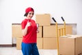 The young female professional mover doing home relocation Royalty Free Stock Photo