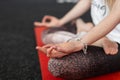 Young female professional is relaxes in lotus position. Woman trainer doing yoga. Close-up Royalty Free Stock Photo