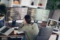 Young female programmer working at a desk with multiple computers coding software in a modern home office Royalty Free Stock Photo