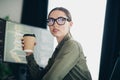 Young female programmer working from home office with a coffee cup, coding and developing software on her computer Royalty Free Stock Photo
