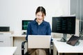 Young female programmer working with tablet and screen displaying code. Modern tech office setup, great for software, coding, IT Royalty Free Stock Photo