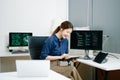 Young female programmer working with tablet and screen displaying code. Modern tech office setup, great for software, coding, IT Royalty Free Stock Photo