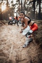 Young female racer with semi naked torso sitting on a grass at sunset in the woods Royalty Free Stock Photo