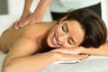 Young female receiving a relaxing back massage in a spa center. Royalty Free Stock Photo