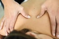 Young female receiving a relaxing back massage in a spa center. Royalty Free Stock Photo