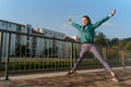 Attractive young woman stretching before her early morning run along the embankment of river. Royalty Free Stock Photo