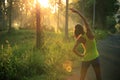 Runner warming up before running at morning forest trail Royalty Free Stock Photo