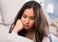 young female sad and thinking on sofa Royalty Free Stock Photo