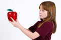 Female school child holding a clear plastic apple