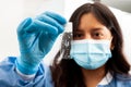 Young female scientist looking at a slide of dewaxed tissue samples in the laboratory. Xylene-based removal of paraffin Royalty Free Stock Photo