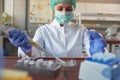 A young female scientist in protective gear working in a laboratory. Science, chemistry, lab, people Royalty Free Stock Photo