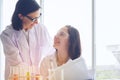 Young female scientist standing with techer in lab worker making Royalty Free Stock Photo