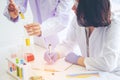 Young female scientist standing with techer in lab worker making Royalty Free Stock Photo