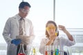 Young female scientist standing with techer in lab worker making Royalty Free Stock Photo