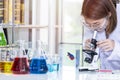 Young female scientist student looking through a microscope Royalty Free Stock Photo