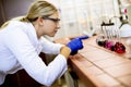 Female scientist in white lab coat analyzing liquid samples the biomedical lab Royalty Free Stock Photo